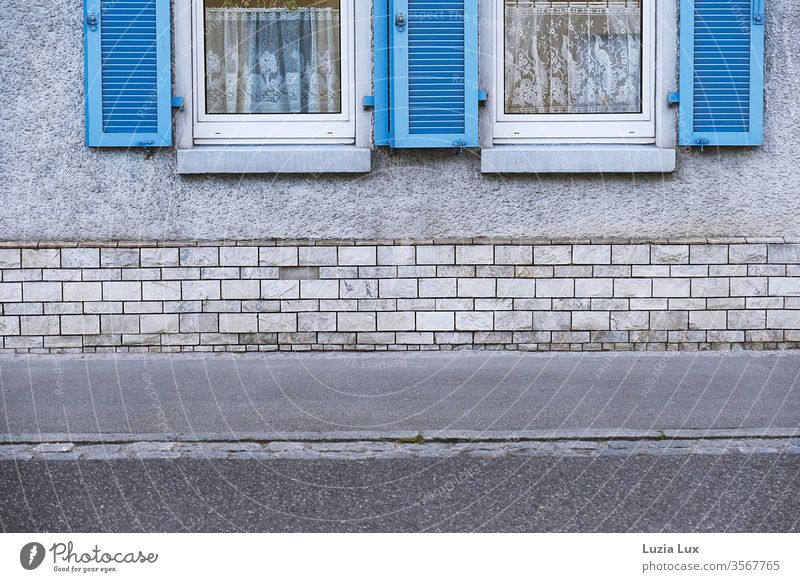 Grey facade with bright blue shutters Wall (building) Street dreariness Town urban Exterior shot Deserted Day Facade Wall (barrier) Lanes & trails