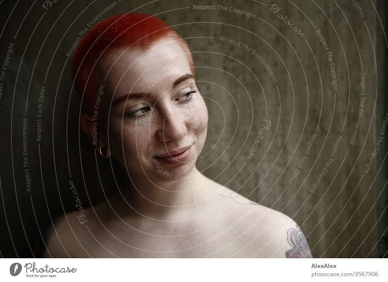 Portrait of a laughing young woman in front of a concrete wall Woman 18-25 years already Slim Freckles Concrete Wall (building) Red-haired Jewellery Piercing