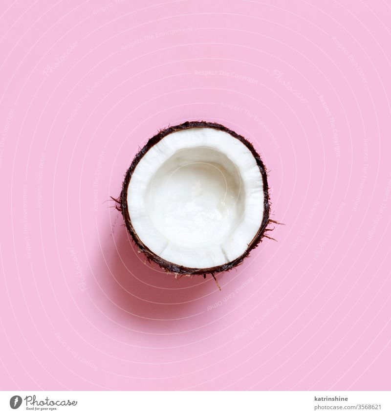 Coconut piece on a light pink background coconut keto fruit top view pastel ingredient nutrition vegan vegetarian veggie white sweet healthy keto diet food half