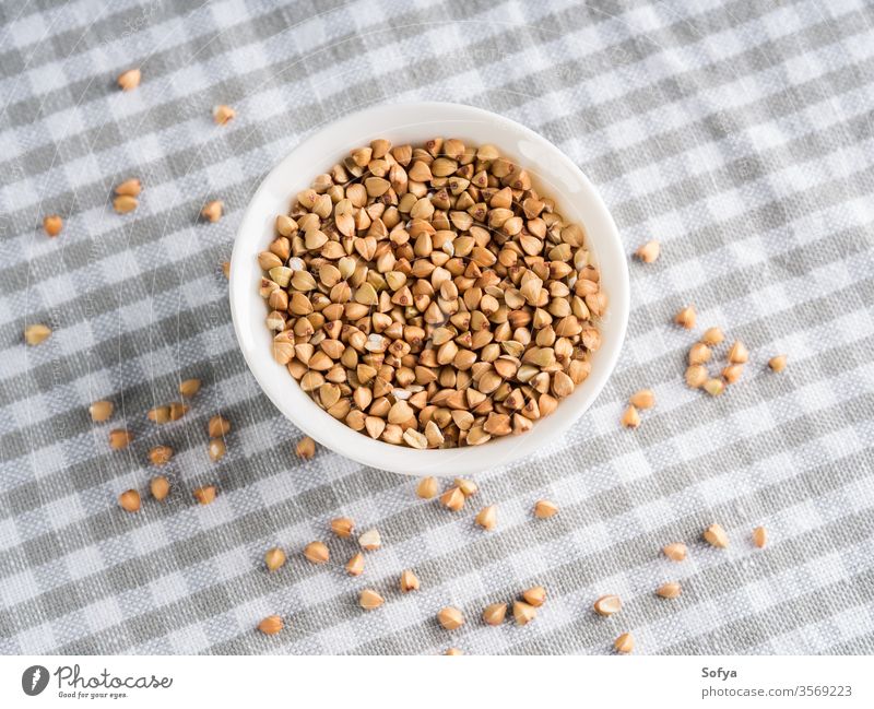 Gluten free grain buckwheat in bowl on kitchen table gluten bowls mix celiac diet food ingredient uncooked white health whole cloth cereal crop healthy