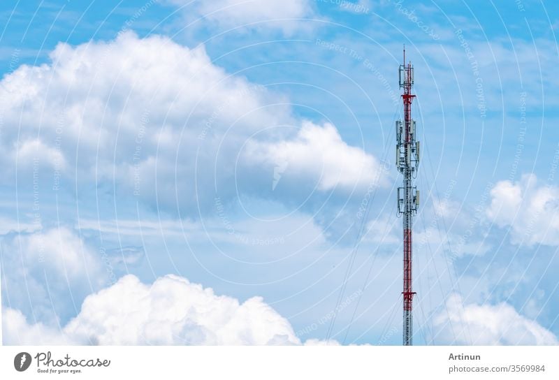 Telecommunication tower with blue sky and white clouds background. Antenna on blue sky. Radio and satellite pole. Communication technology. Telecommunication industry. Mobile or telecom 4g network.