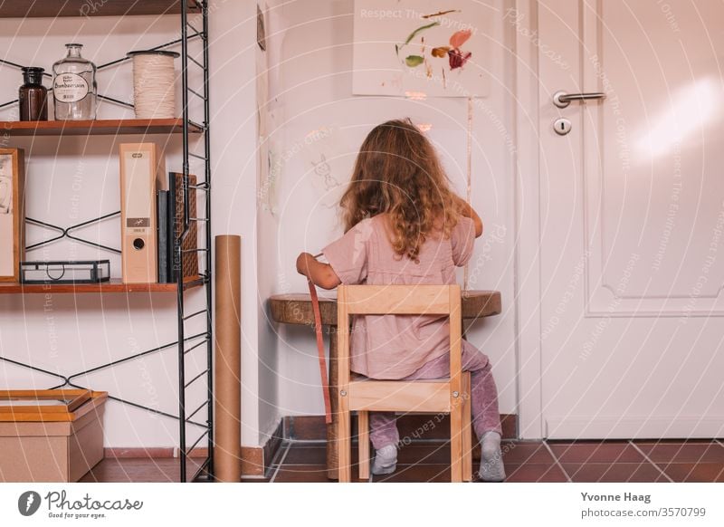 Girl with long hair sits at her desk and tinkers Child Handicraft craft technique Colour photo Infancy 3 - 8 years Playing Human being Leisure and hobbies Joy