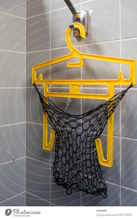 yellow hanger in changing room Yellow Gray Black hangers plastic Swimming pool Net Checkmark Corner tile tiles Sports dressing cabin Family free time wardrobe