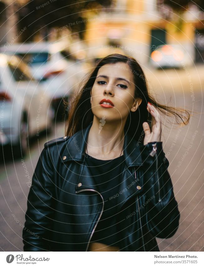 Portrait of a cute model wearing denim jacket. bokeh lights brunette face trendy natural real people Exterior shot Loneliness Dress Young woman Woman