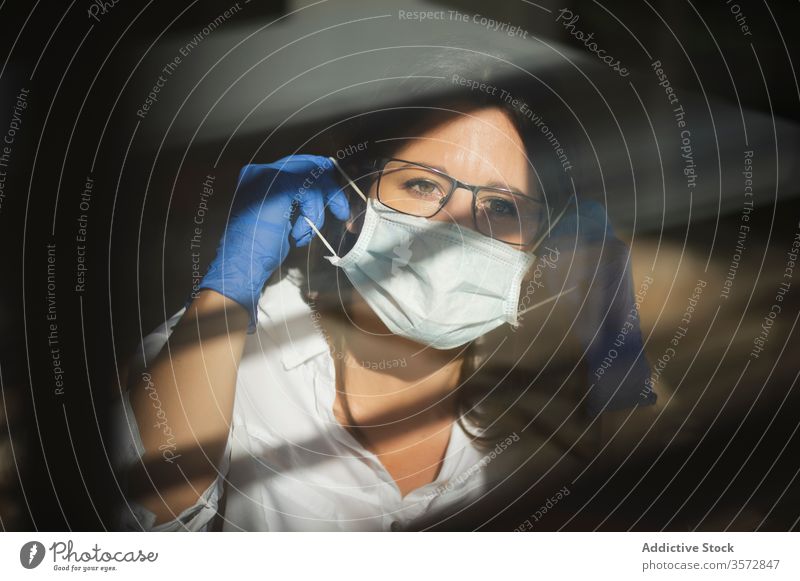 Woman in protective mask and gloves working at home woman coronavirus covid safety pandemic risk window disease female serious outbreak put on infection prevent