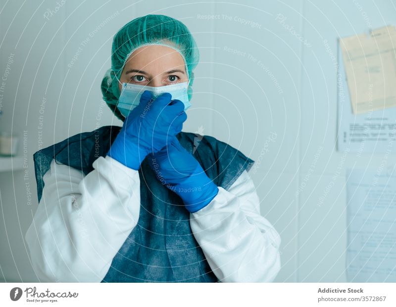 Female doctor in protective mask and goggles medical coronavirus covid woman nurse safety wear put on uniform disease covid19 covid 19 pandemic epidemic