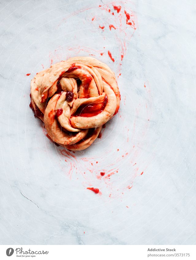 Fresh strawberry brioche on the making on a marble table fruit preserve butter flour filling pastries natural light sweet food wreath sugar filled jam kitchen