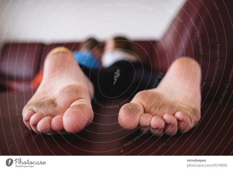 Dirty feet on the new sofa foot Toes frowzy Wide angle Sofa children Infancy Lie Reading Playing Barefoot Summer at home stay at home shallow depth of field