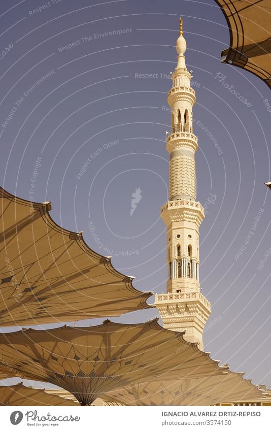 Medina mosque minaret and sun umbrellas wanderlust wonder human icon slim harmonic beauty islamic art culture city holy place holiday travel icons pilgrimage