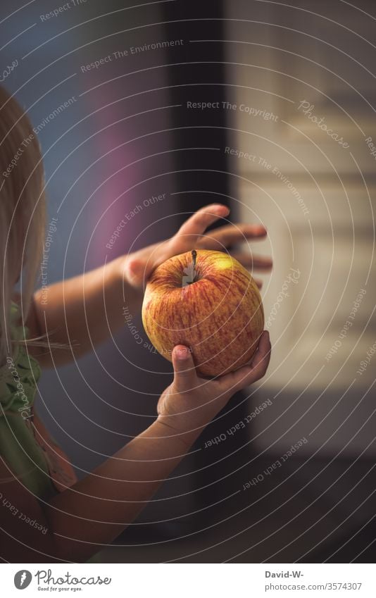 Child holds an apple in his hands apples by hand stop Retentive To hold on present salubriously Nutrition Healthy Eating vitamins Vitamin B Vitamin A fruit