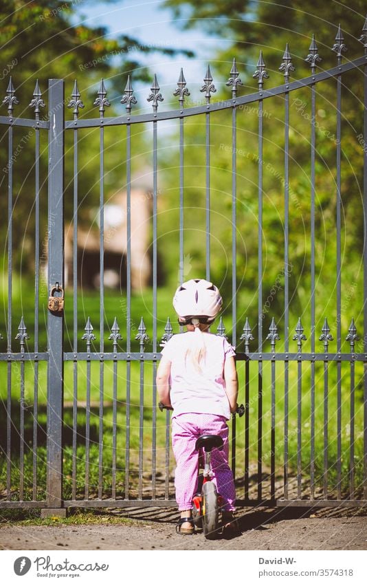 at locked gates girl closed Goal door Fence Grating too Bicycle Cycling No trespassing completed Padlock Lock Castle grounds Private private premises Looking