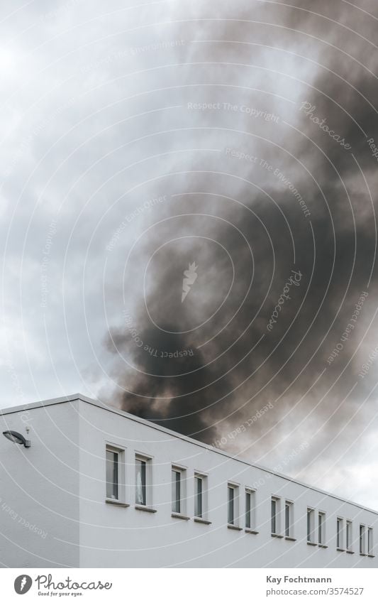 smoke of a fire in industrial district house building old retro urban cityscape factory grunge dark warehouse dramatic destruction abandoned weather destroyed