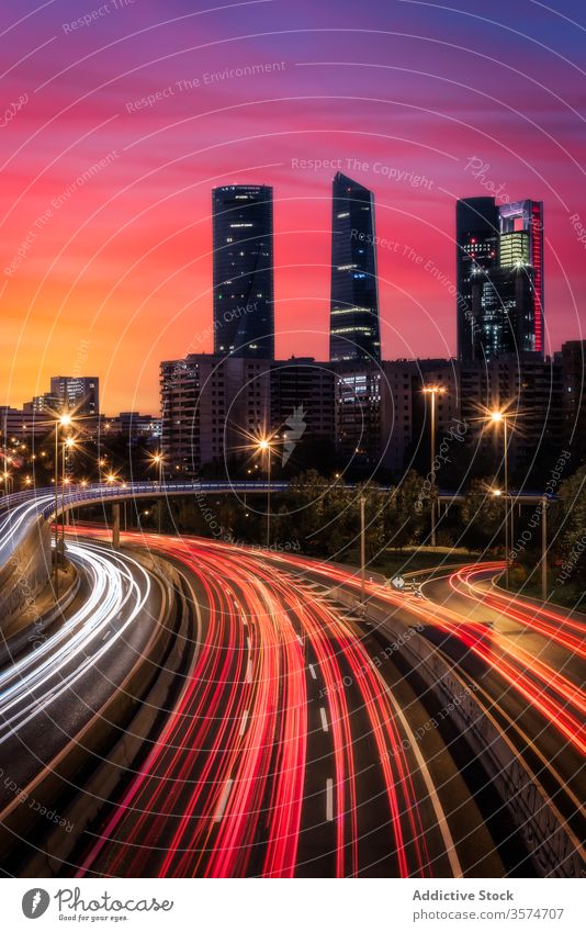 Traffic on city road in majestic evening cityscape highway traffic luminous sunset urban skyscraper downtown dusk building architecture modern landscape