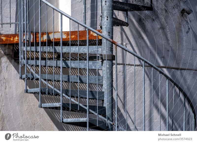 Spiral staircase outside in metal and with grating Winding staircase Stairs Architecture Banister Handrail Go up Upward Shadow Deserted