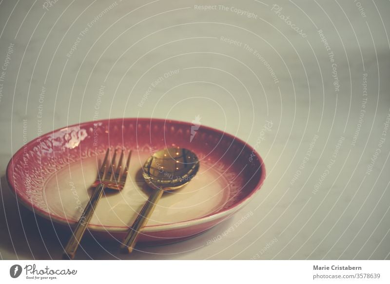 Empty plate at a closed up restaurant shows the loneliness, economic crisis and depression brought about by social distancing, lock down and self isolation due to the covid-19 pandemic