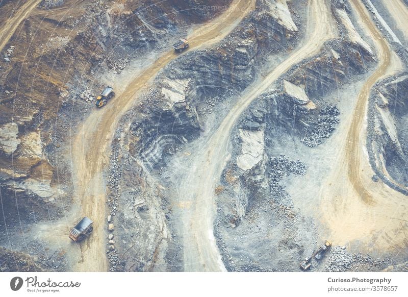 Mining from above. Industrial terraces on open pit  mineral mine. Aerial view of opencast mining. Dolomite Mine Excavation. Extractive industry. Giant excavator machinery.