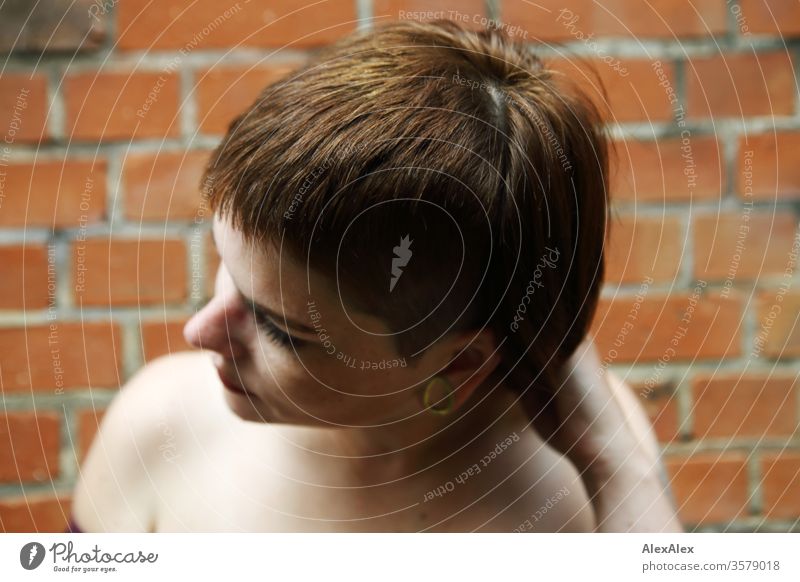 Portrait of a young woman in front of a brick wall Free Wild Cheerful confident Trust Copy Space right Cool (slang) Copy Space left portrait Self-confident