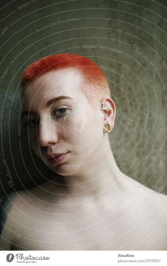 Portrait of a young woman in front of a concrete wall Punk Alternative urban Town Life Uniqueness Identity Style Authentic Esthetic Central perspective Looking