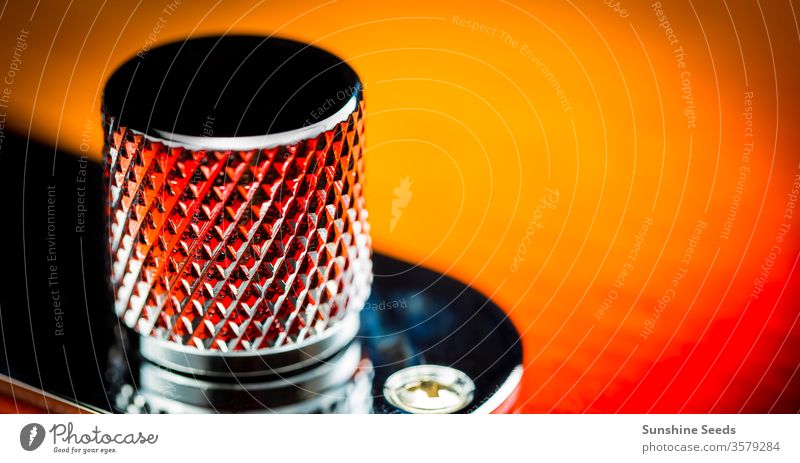 Macro close up of an electric guitar volume knob with interesting pattern musical instrument macro vintage dial wooden closeup control turn texture twist