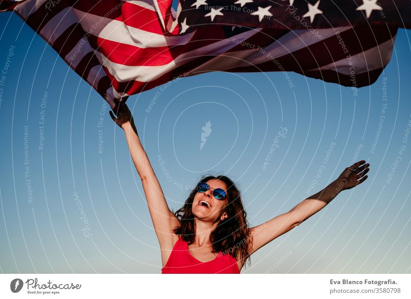 young woman holding United States flag outdoors at sunset. Independence day in America, 4th July concept united states independence day july america freedom