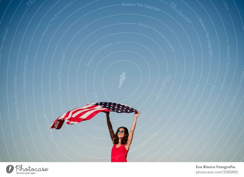 young woman holding United States flag outdoors at sunset. Independence day in America, 4th July concept united states independence day july america freedom