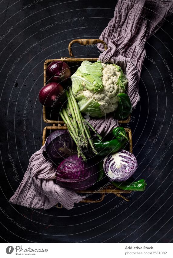 Basket of fresh vegetables on dark table basket food vegetarian vegetate meal vitamin healthy edible harvest ripe raw various cabbage cauliflower asparagus