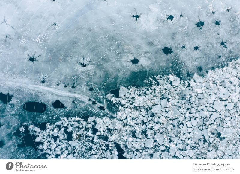 Glacier Lagoon with icebergs from above. Aerial View. Cracked Ice from drone view. Background texture concept. blue glacier water white nature landscape arctic