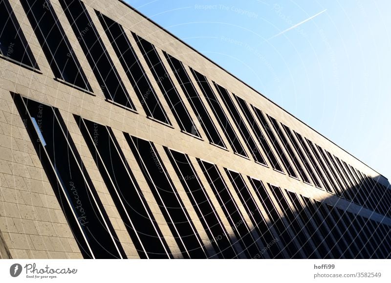 Shadow play with contrails in the sky Vapor trail Aviation Airplane Climate change Facade Window Venetian blinds Architecture Bank building