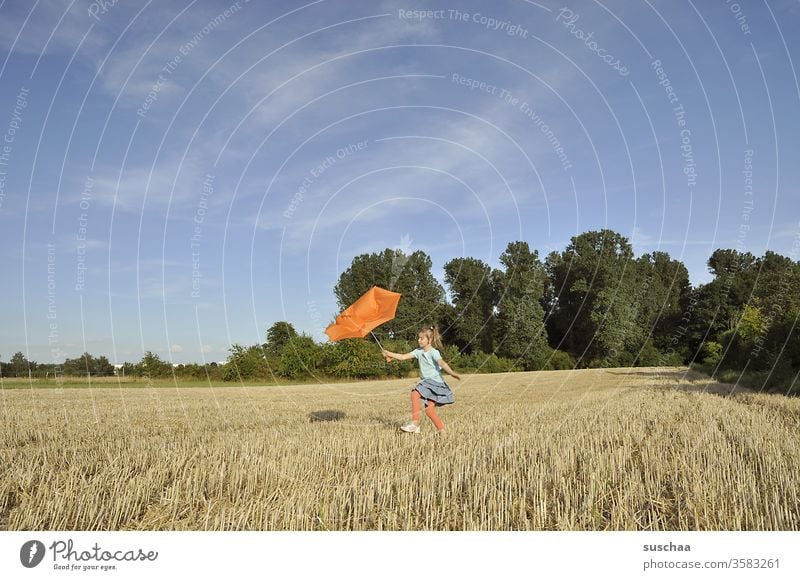 child with a broken orange umbrella on a summery stubble field Child girl Summer out Summery Beautiful weather Nature Landscape Stubble field straw field acre