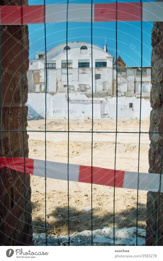 demolition building behind barrier tape Barred wall passage Grating demolition site built Caution forbidden no passage Territory Town Building site