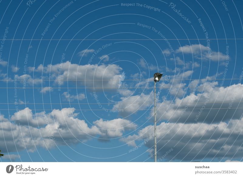 sky with clouds, power cables and a floodlight Sky Clouds Beautiful weather Weather Day daylight Floodlight Sporting grounds amateur football field Sports