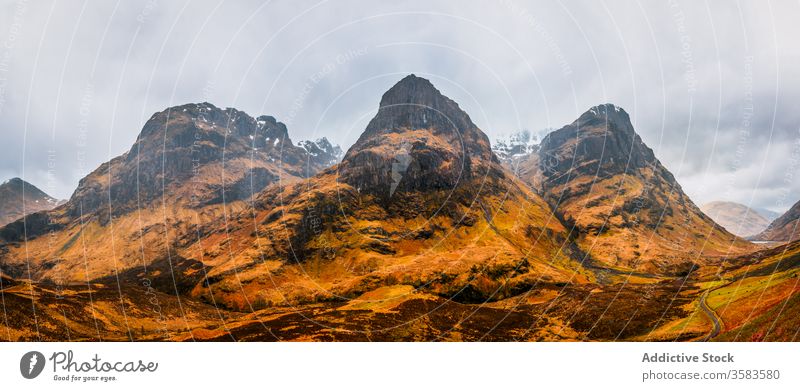 Remote road in endless mountainous valley highland rock nature landscape countryside route ridge range terrain scotland glen coe sky cloudy grass spring travel