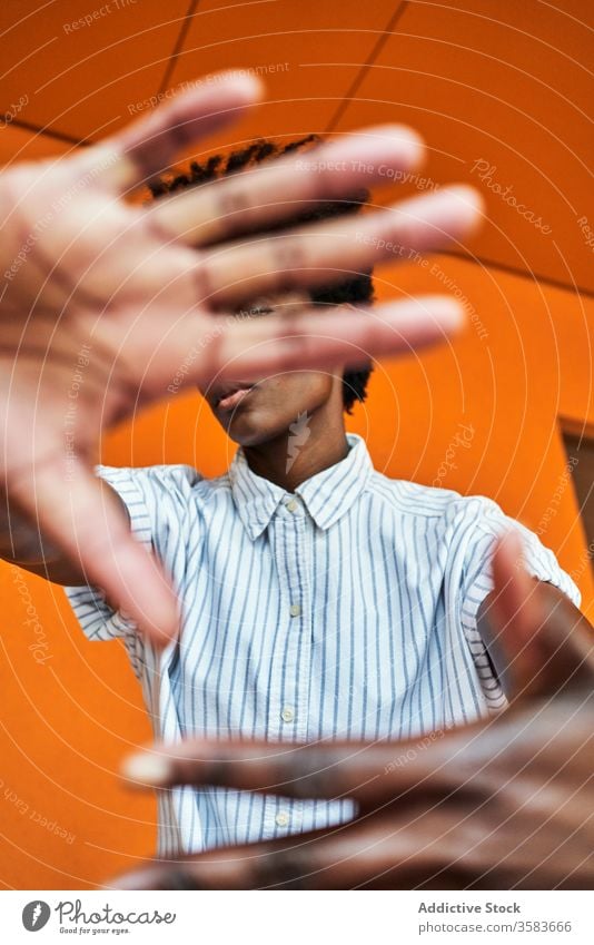 Serious black woman with hands raised protesting and trying to stop violence prevent against gesture sign dissuade objection concept renouncement refuse serious