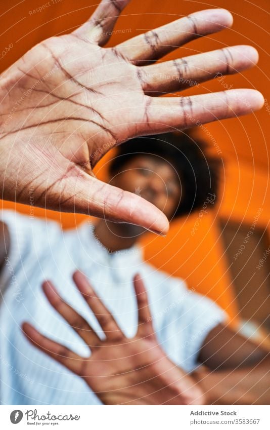 Serious black woman with hands raised protesting and trying to stop violence prevent against gesture sign dissuade objection concept renouncement refuse serious