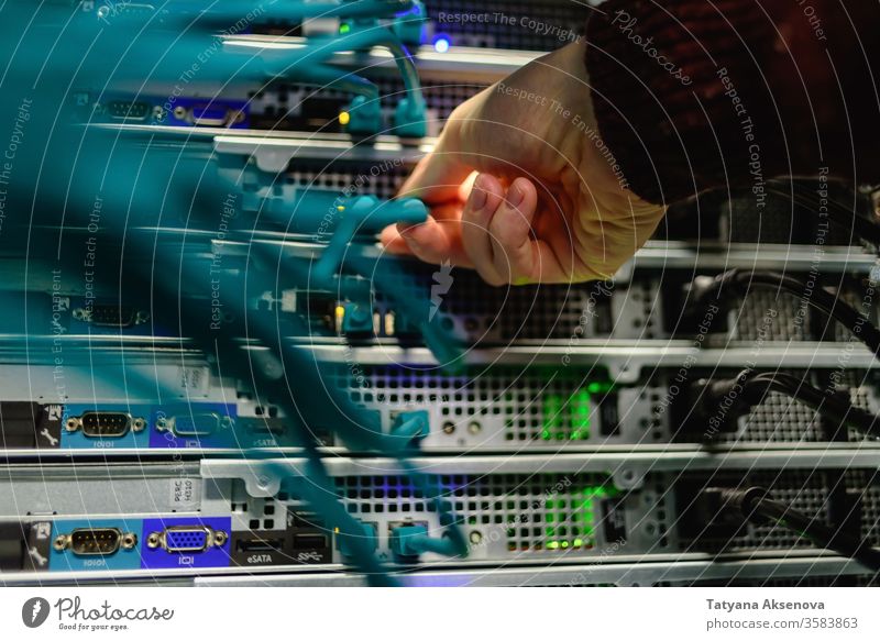 Man data center technician performing server maintenance infrastructure engineer rack cables replacing blade mounted fiber optics rj45 recovery man working it