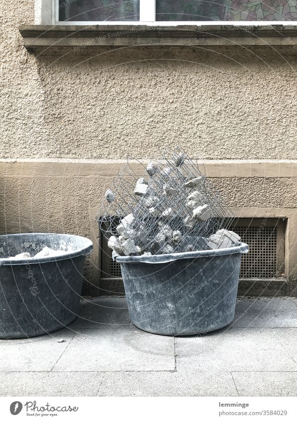 Bucket with building rubble in front of a facade Ripe for demolition House (Residential Structure) Gloomy Termination rubbish dump Rest of a wall Change