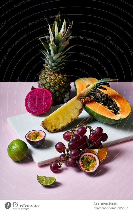 Still life with tropical fruits exotic papaya hawaii ingredients natural organic food pitaya dragon passion green colorful juicy sweet ripe vegetarian