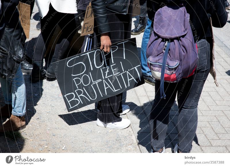 Stops police brutality, demonstrator with protest sign in hand on the fringes of a demonstration against racism and police violence Demonstration Police Force