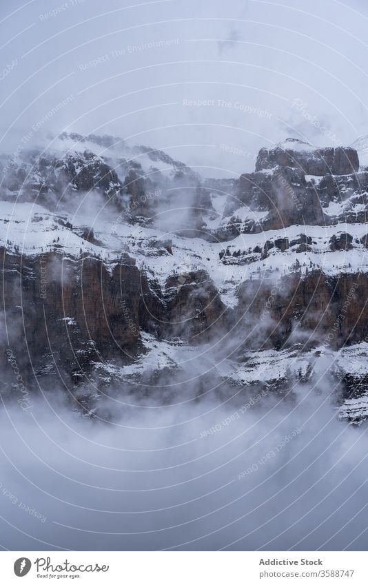 Mountain covered with snow and fog in winter mountain landscape breathtaking haze spectacular idyllic nature scenery picturesque climate range gloomy tranquil