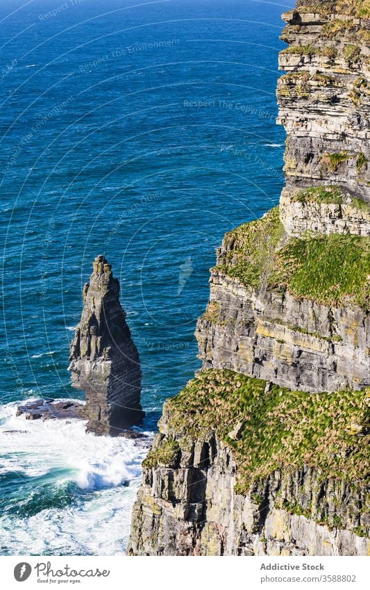 Rocky cliff above ocean foamy waves giant remote wild landscape scenic huge gigantic seaside ireland heaven coastline distance sky nature power height