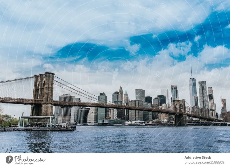 Brooklyn bridge over river in New York City brooklyn bridge suspension cityscape skyscraper spectacular urban landmark new york manhattan america skyline