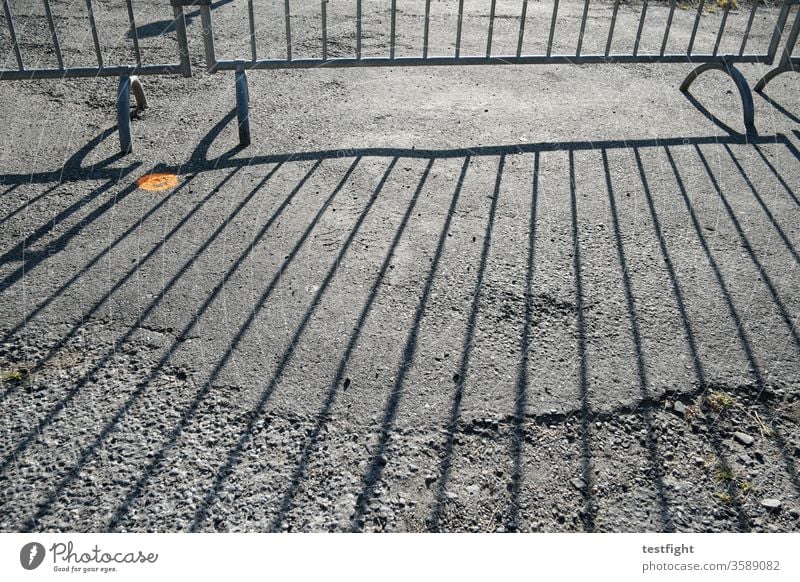 crowd barriers cordon Grating Fence mobile Divide Shadow shadow cast Sunlight Ground Tar Asphalt dilapidated Back-light