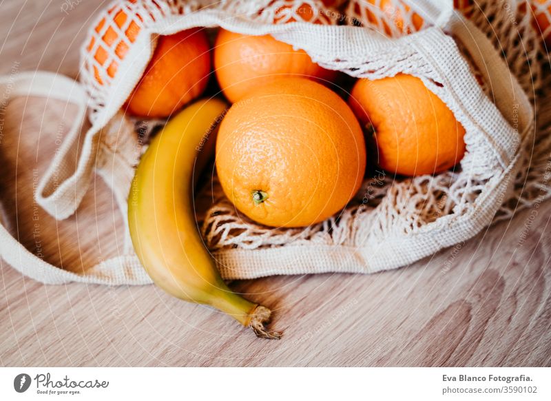 Zero waste concept. Modern shopping white textile bag with fruits. Top view. zero waste cotton bag orange strawberries banana nobody market produce reduce