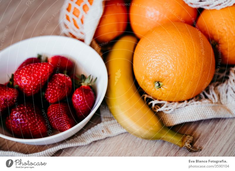 Zero waste concept. Modern shopping white textile bag with fruits. Top view. zero waste cotton bag orange strawberries banana nobody market produce reduce