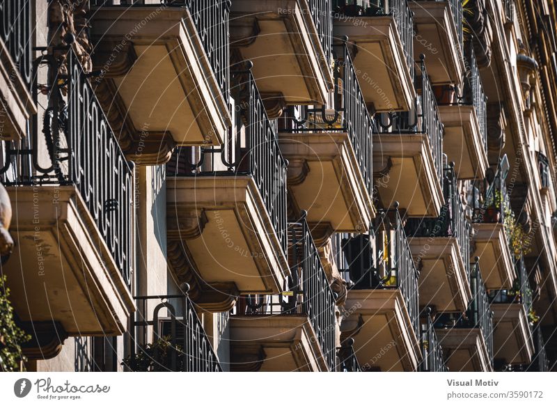 Low angle view of rows of neoclassical balconies on the facade of a residential building pot balcony plant exterior ornament construction old style railing