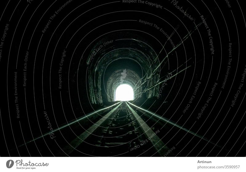 Train tunnel. Old railway in cave. Hope of life in the end of the way. Railroad of locomotive train in Thailand. Old architecture. Railway tunnel built in 1914. Travel and hope at the destination.