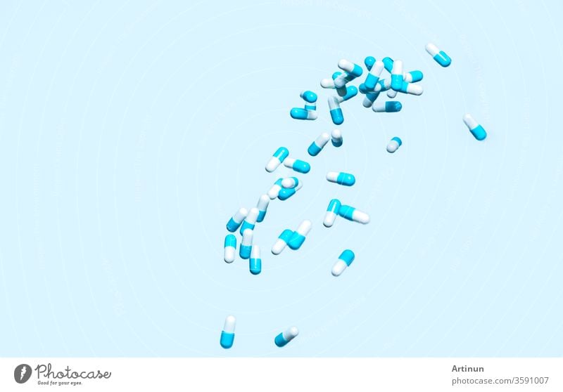 Blue-white capsule pill fall down. Antibiotic drug use with reasonable. Antibiotic drug resistance. Pharmaceutical industry. Antimicrobial drug market. Drug interaction. Medication use in hospital.