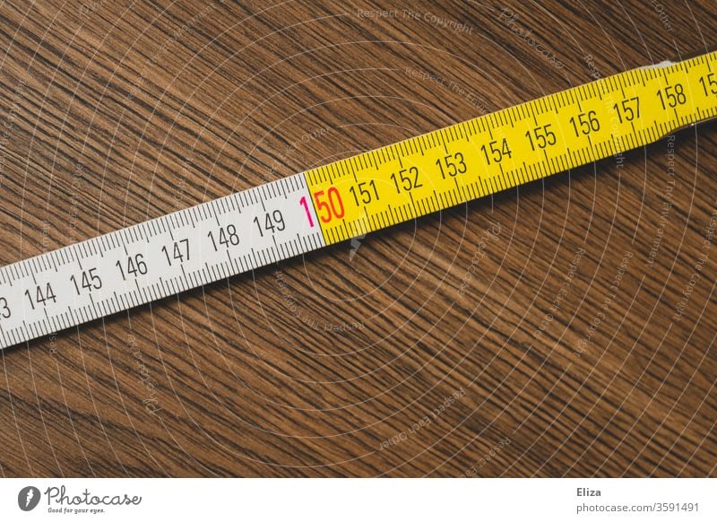 Scale of a meter rule. 150 cm or 1.5 meter distance. Social Distancing. Distance rules. gap Meter rule scale keep sb./sth. apart social distancing wood measure