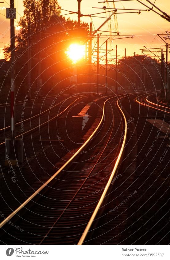 Sunset turning rail track into golden path dusk evening light line melancholy railroad railway speed steel sunset traffic train transport travel urban