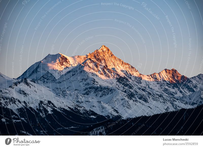 Swiss alps at golden hour sunset during the cold winters of Crans Montana, Switzerland alpine awe breathtaking clouds fiery freezing geological formation